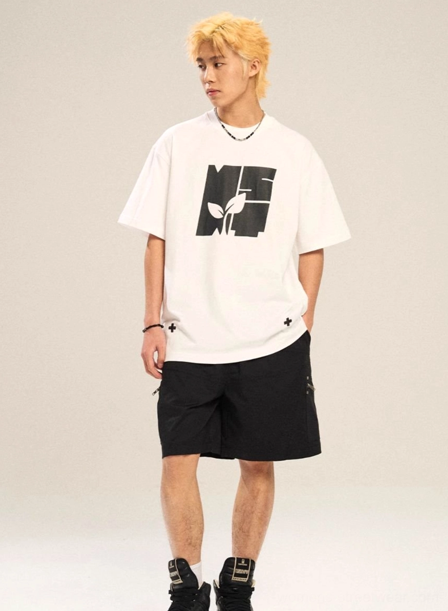 White oversized graphic T-shirt with black contrast botanical logo, cross embroidery, and loose drop-shoulder Y2K streetwear silhouette
