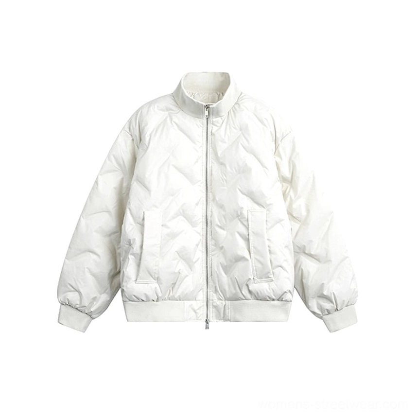 Flat front studio view of a white oversized chevron quilted puffer bomber jacket with neutral matte shell, ribbed cuffs, and ribbed hem