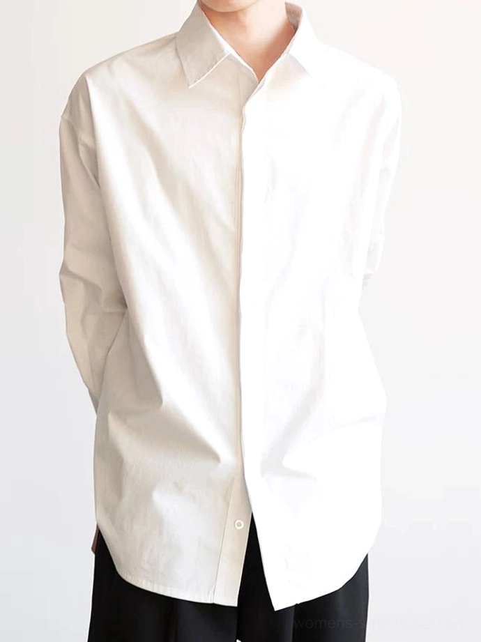 White oversized cotton poplin shirt with hidden button placket curved hem and relaxed minimalist fit