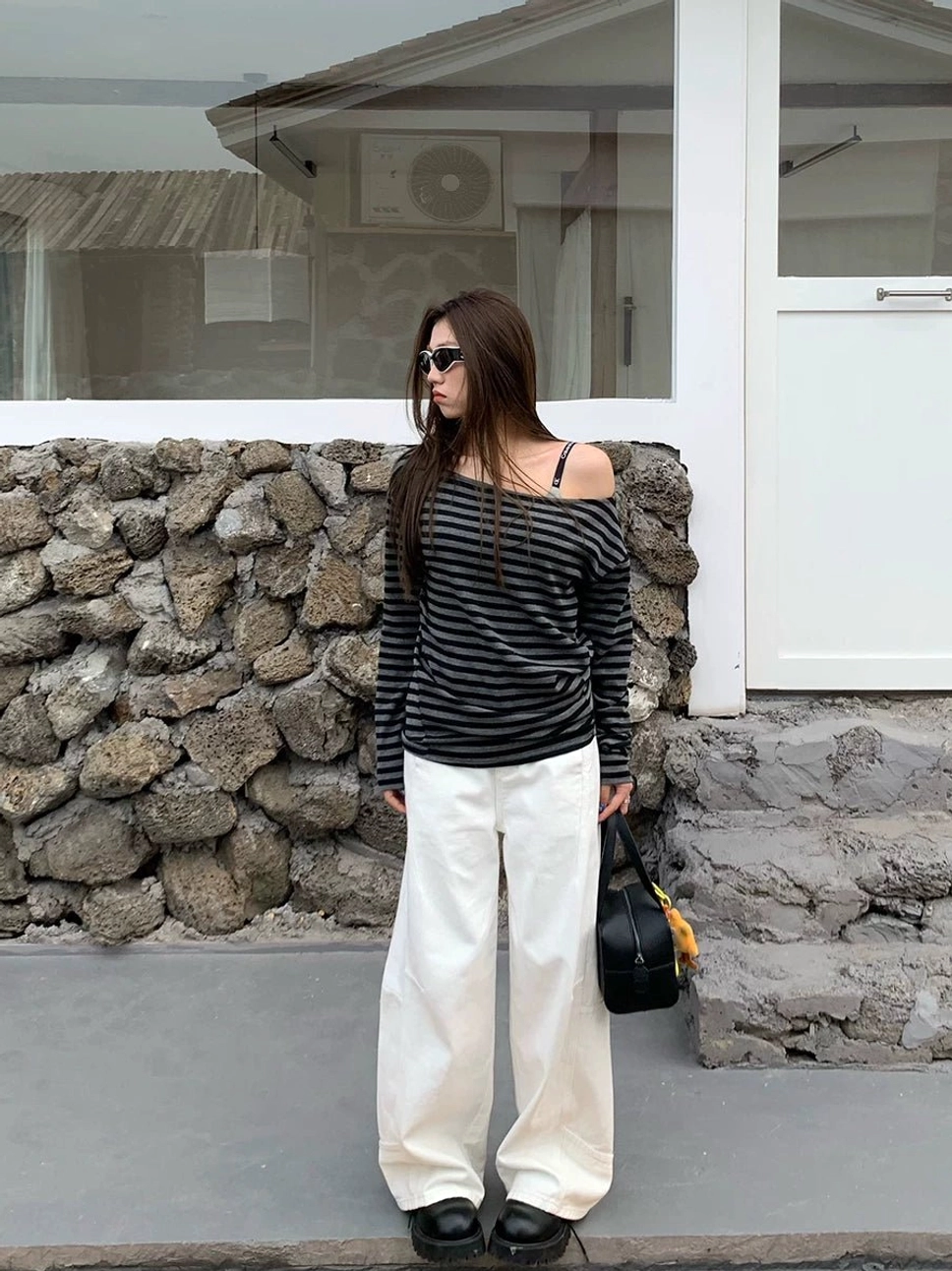 White panel-seam wide-leg jeans shown in a full-body front view with a relaxed streetwear silhouette and floor-grazing leg
