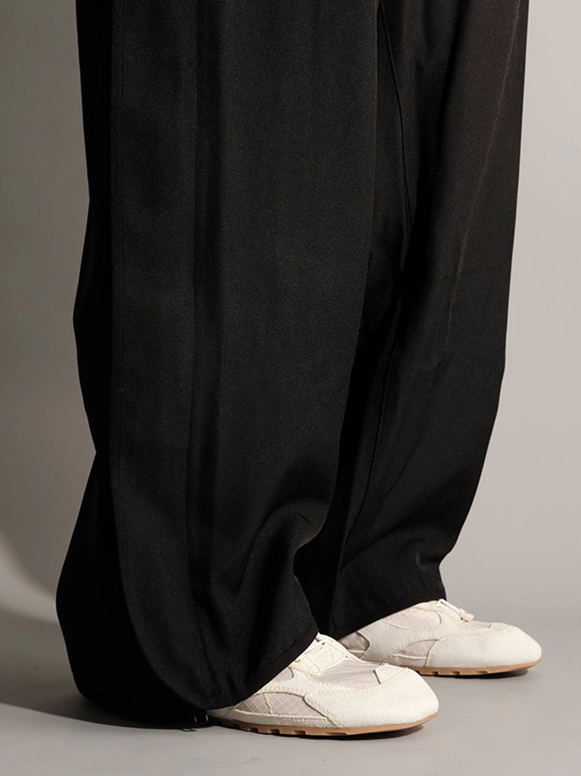 Side rear view of white paneled nubuck trainers with slim gum rubber sole