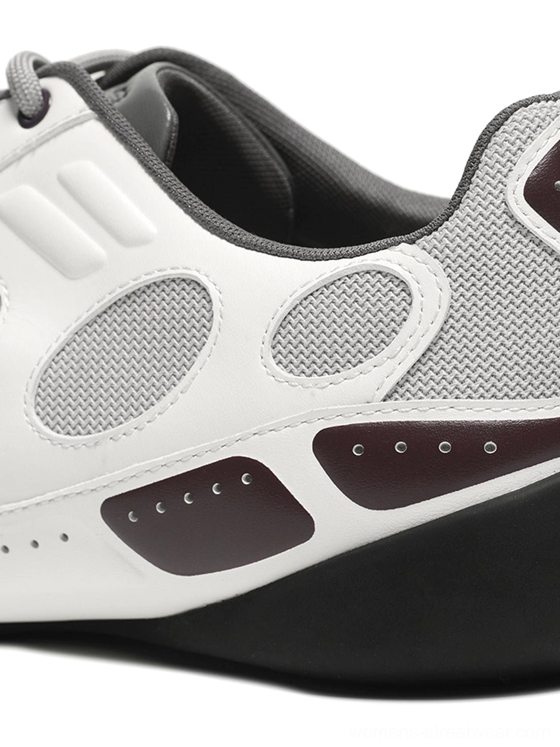 Rear side close-up of white perforated retro sport sneaker showing burgundy heel accents grey lining and black rubber outsole