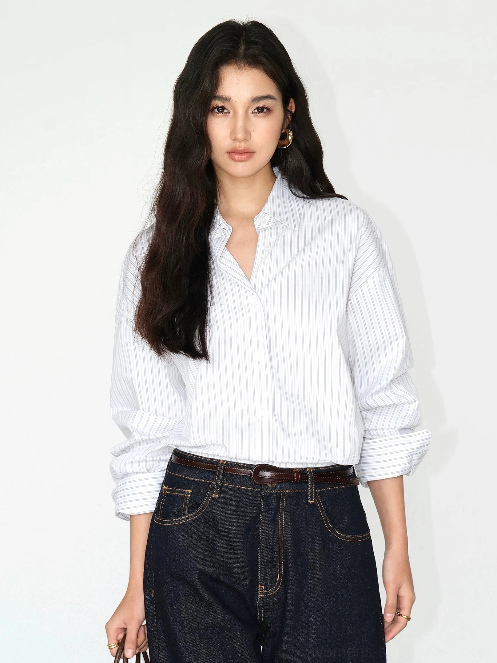 White pinstripe oversized button-up shirt full body front view with pointed collar and relaxed long sleeves