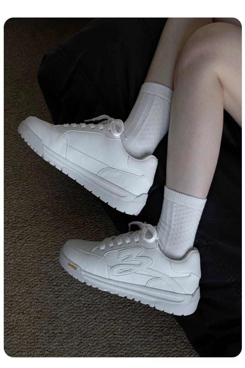 White flame embossed platform sneakers worn with white crew socks in a relaxed casual streetwear outfit