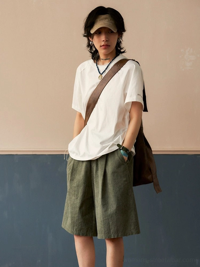 White raglan sleeve crew neck t-shirt with clean pure color, styled with green wide leg shorts and canvas crossbody bag