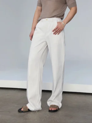 White relaxed straight-leg jeans shown from the front with button waistband, subtle slub denim texture, and wide straight silhouette