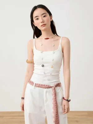 White ribbed camisole tank top styled with a flower pendant necklace and printed waist scarf in a clean Korean streetwear outfit