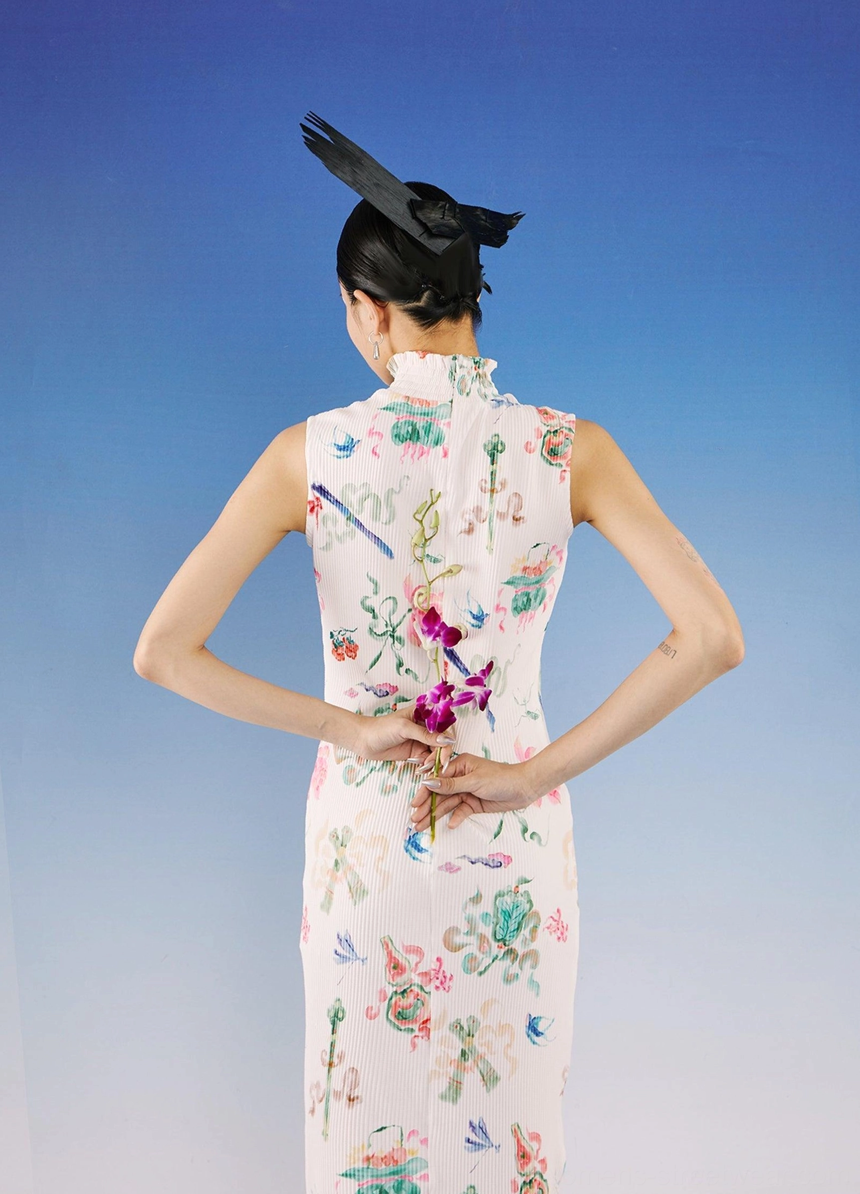 Back view of white ribbed floral qipao-inspired midi dress with all-over watercolor print and elegant fitted streetwear silhouette