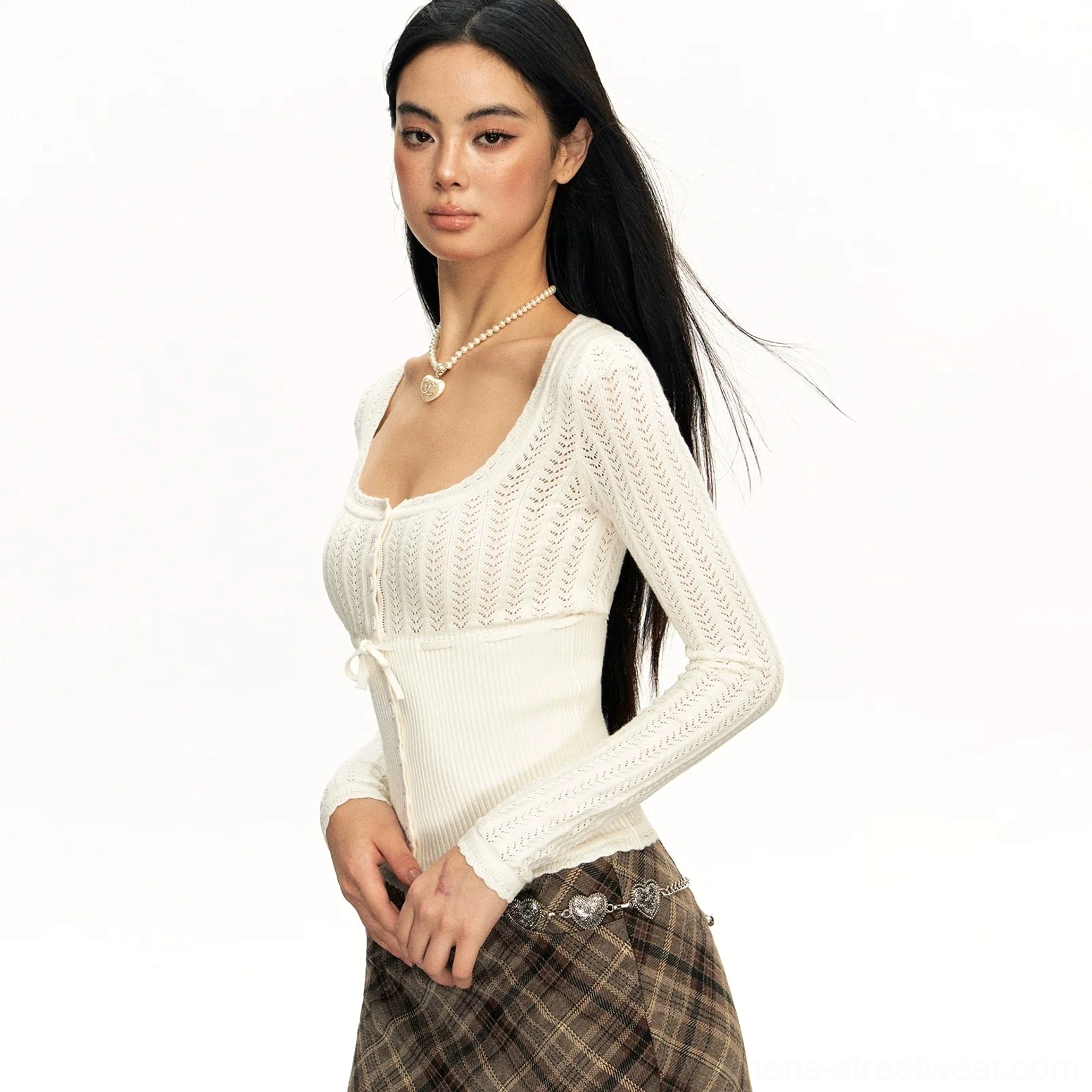 White ribbed hollow-knit cardigan shown from the side with a slim cropped fit, long sleeves, square neck, and delicate lace texture