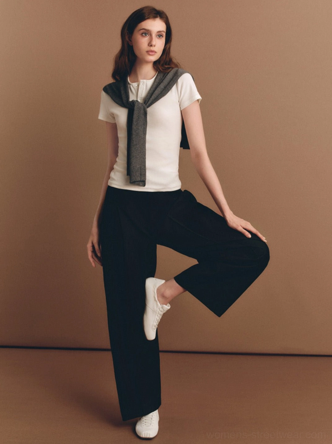 White ribbon lace retro trainers styled with casual workwear in a warm studio setting for women's streetwear fashion