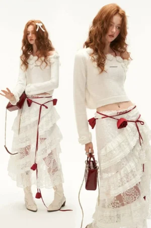 White off-shoulder cropped knit sweater with three-dimensional floral appliqués and romantic lace skirt styling