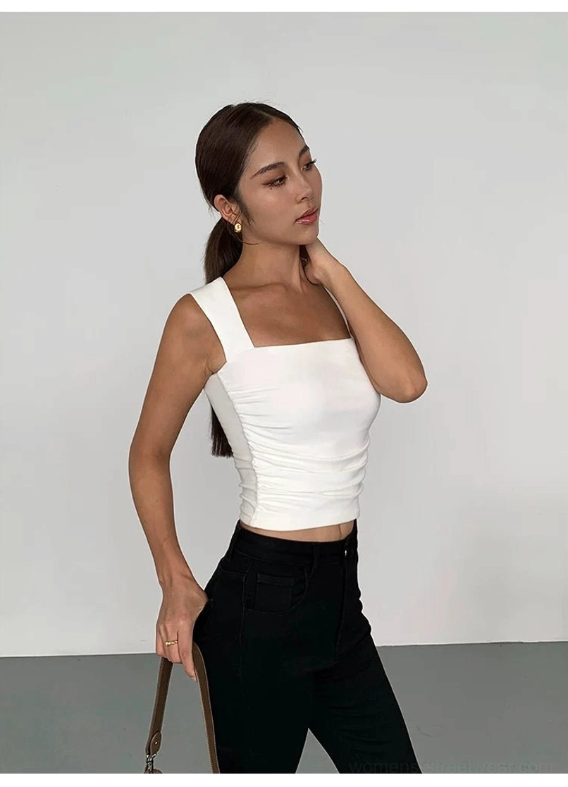 White ruched square neck cropped tank top in side profile with black pants and brown shoulder bag