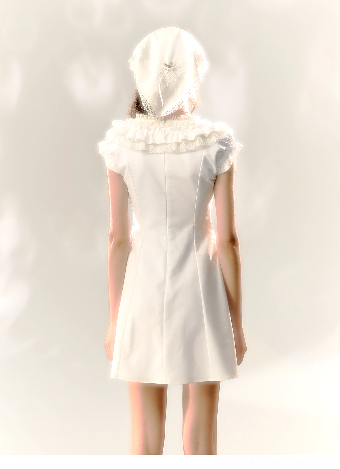 Back view of white ruffle cotton Victorian mini dress with fitted bodice and A-line mini skirt