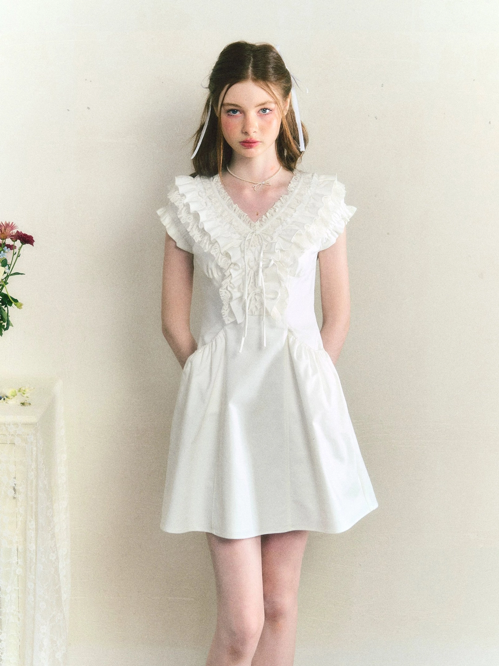 White ruffle cotton Victorian mini dress front view with drawstring V-neck and A-line skirt