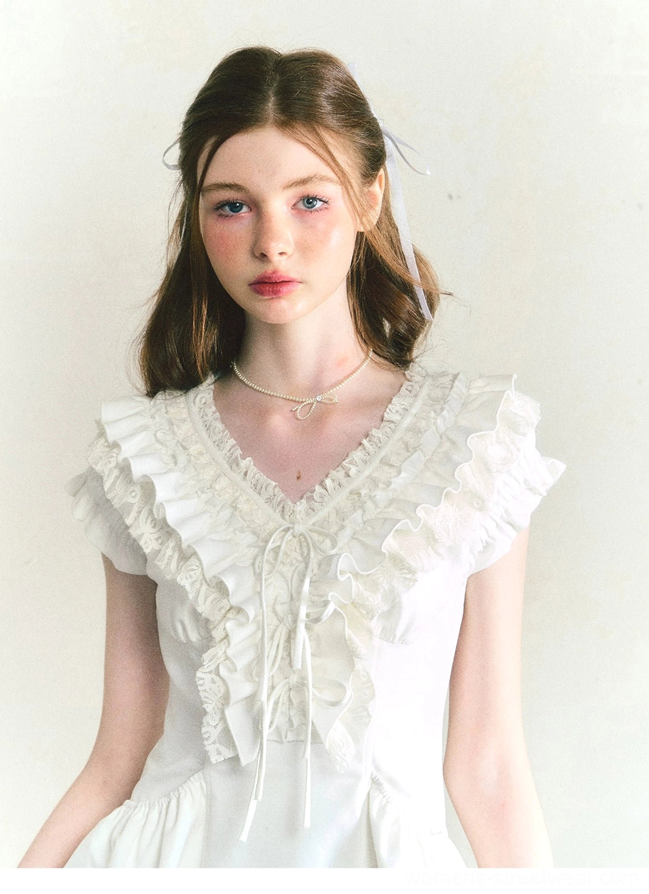 Close-up of white ruffle cotton Victorian mini dress neckline with layered ruffles and front drawstring