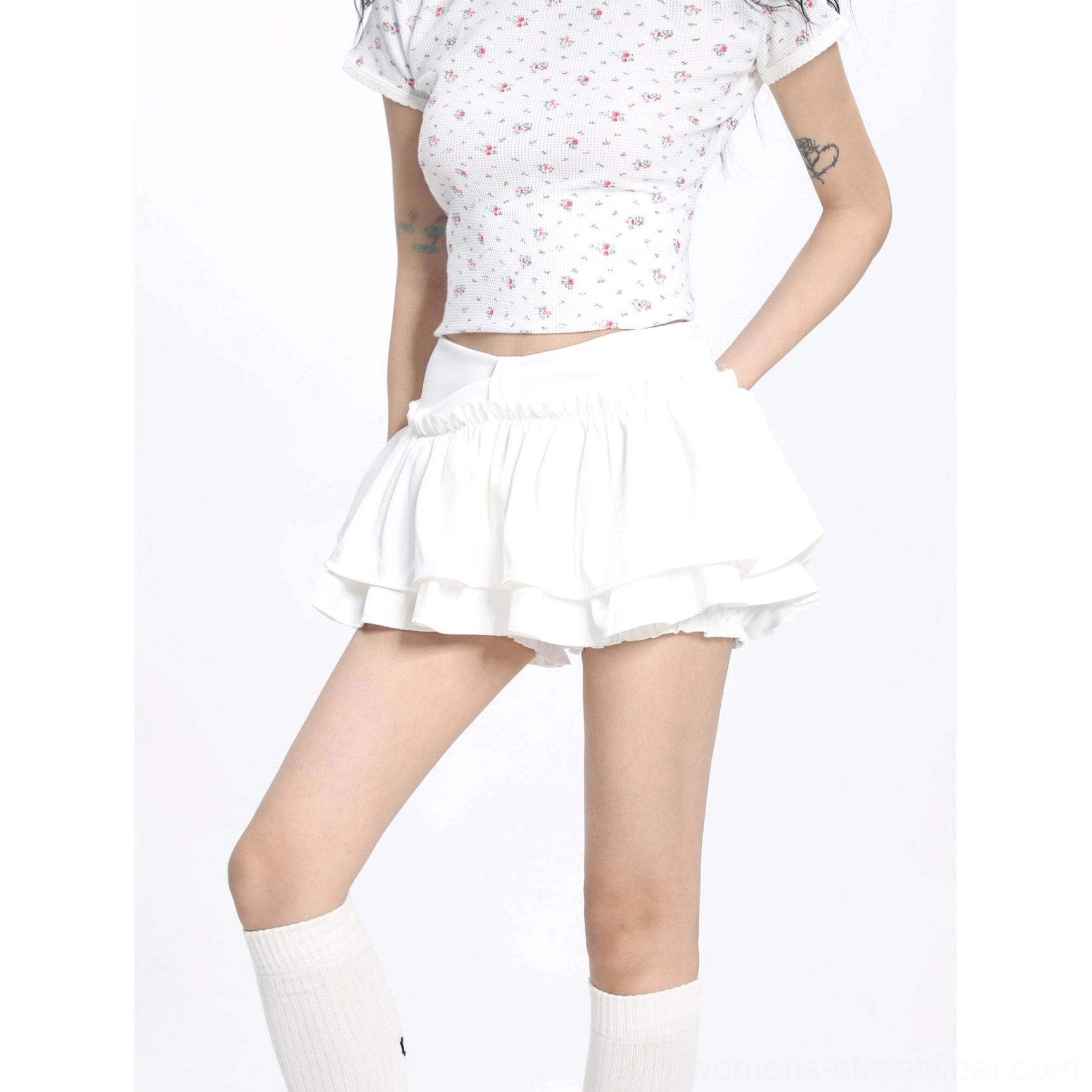 Close front view of a white ruffled mini skirt with a neat waistband and double tiered hem styled in a Korean fashion outfit