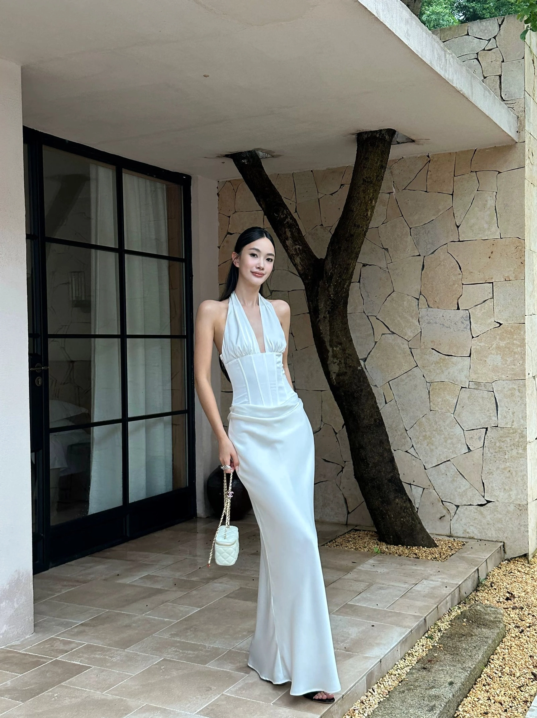 White satin corset maxi dress featuring a structured bodice, softly draped waist, slim silhouette, and floor-length hem