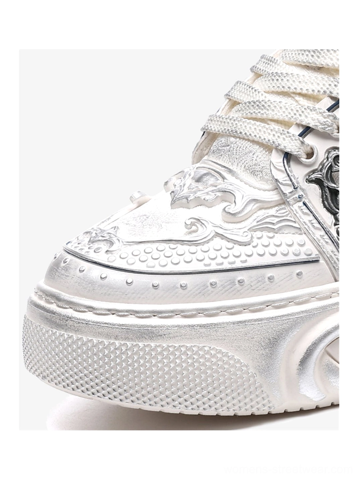 White sculpted platform sneakers with distressed texture, bone-inspired relief panels, curled laces, and wave-molded streetwear sole