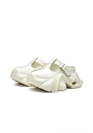 White sculpted closed-toe platform slides with smooth leather-look upper, buckle T-strap, and chunky hollow heel sole