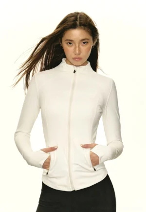 Front view of white sculpted mock neck zip-up athletic streetwear jacket with thumbhole cuffs and zip pockets