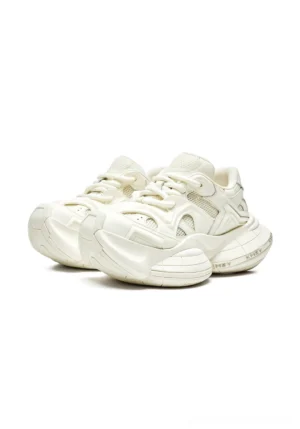 White sculpted-sole chunky sneakers in a front three-quarter view with breathable mesh upper, curved leather overlays, tonal laces, and elevated platform sole