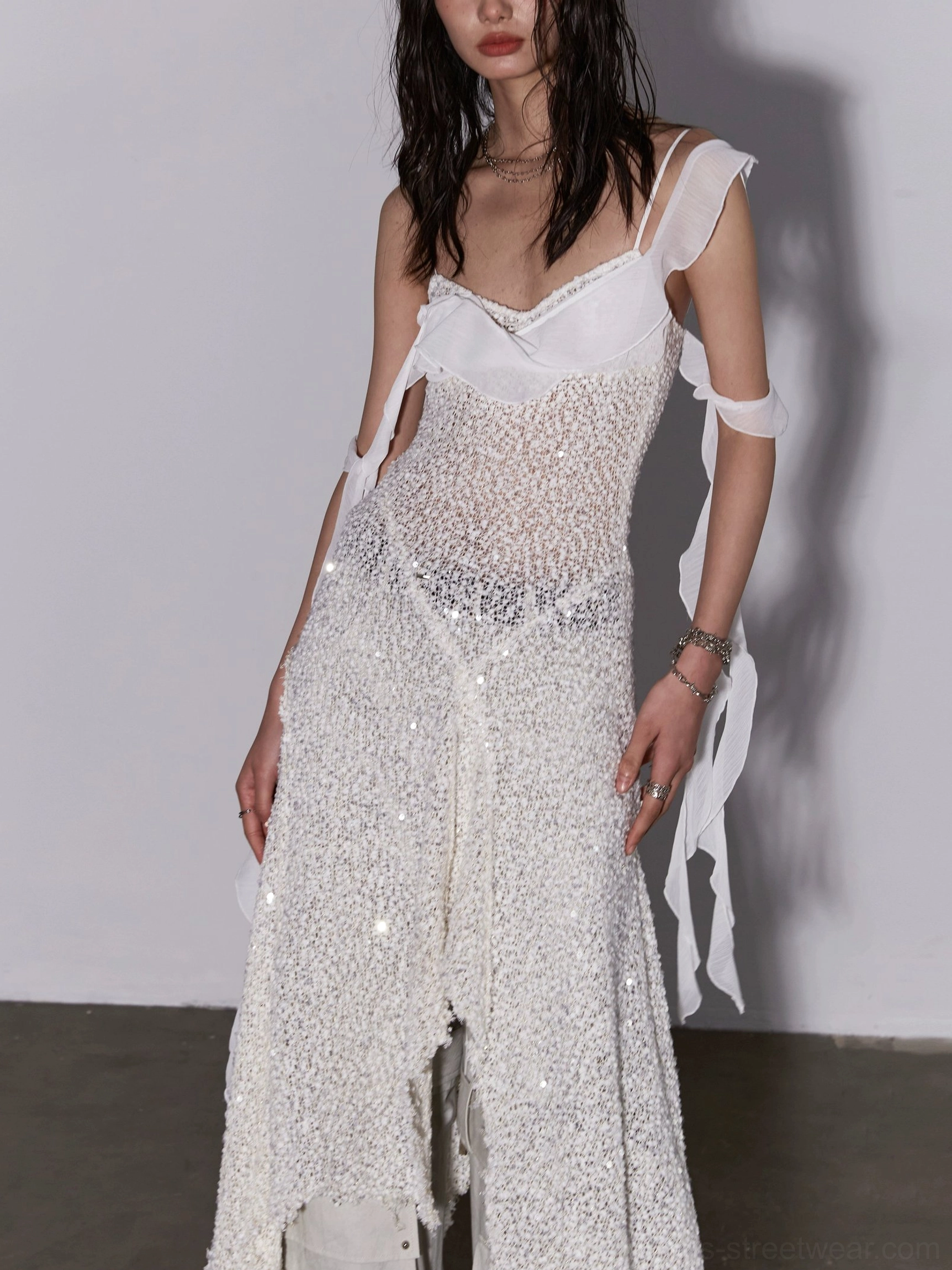 Detailed front view of white sequin mesh layered dress showing sparkling texture beaded waist trim and shoulder strap accents