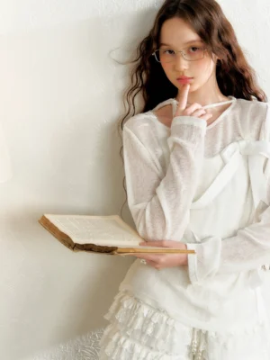 White sheer bow detail top shown in a relaxed indoor Korean fashion outfit with a delicate romantic aesthetic