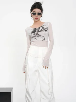 White sheer mesh floral graphic long sleeve crop top with asymmetrical neckline styled with white cargo pants