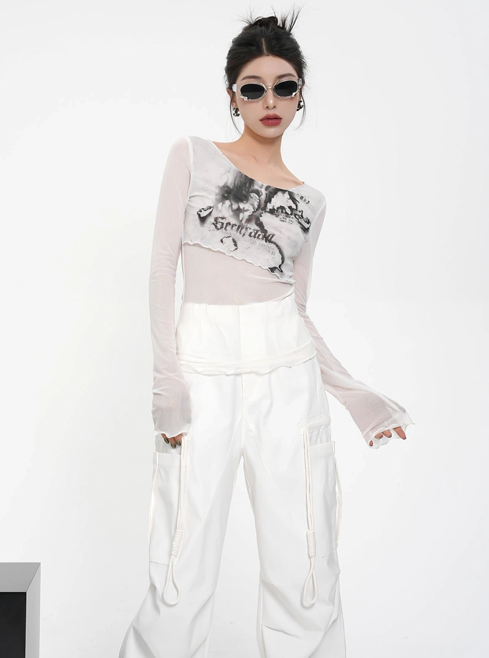 Fitted white sheer mesh graphic print crop top with long sleeves and romantic floral streetwear styling