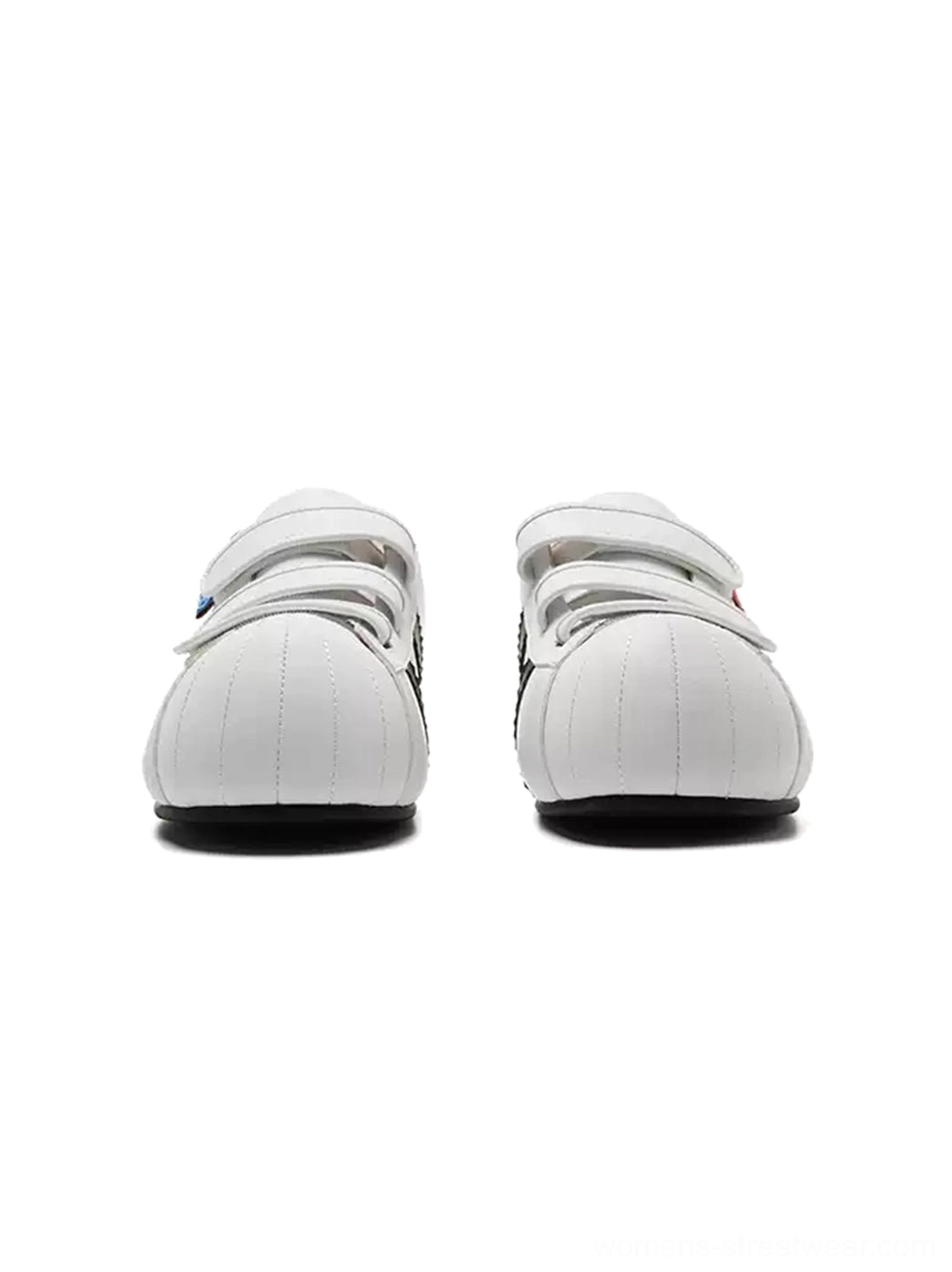 Pair of white shell toe strap sneakers showing the rounded oversized toe shape and concealed lift design
