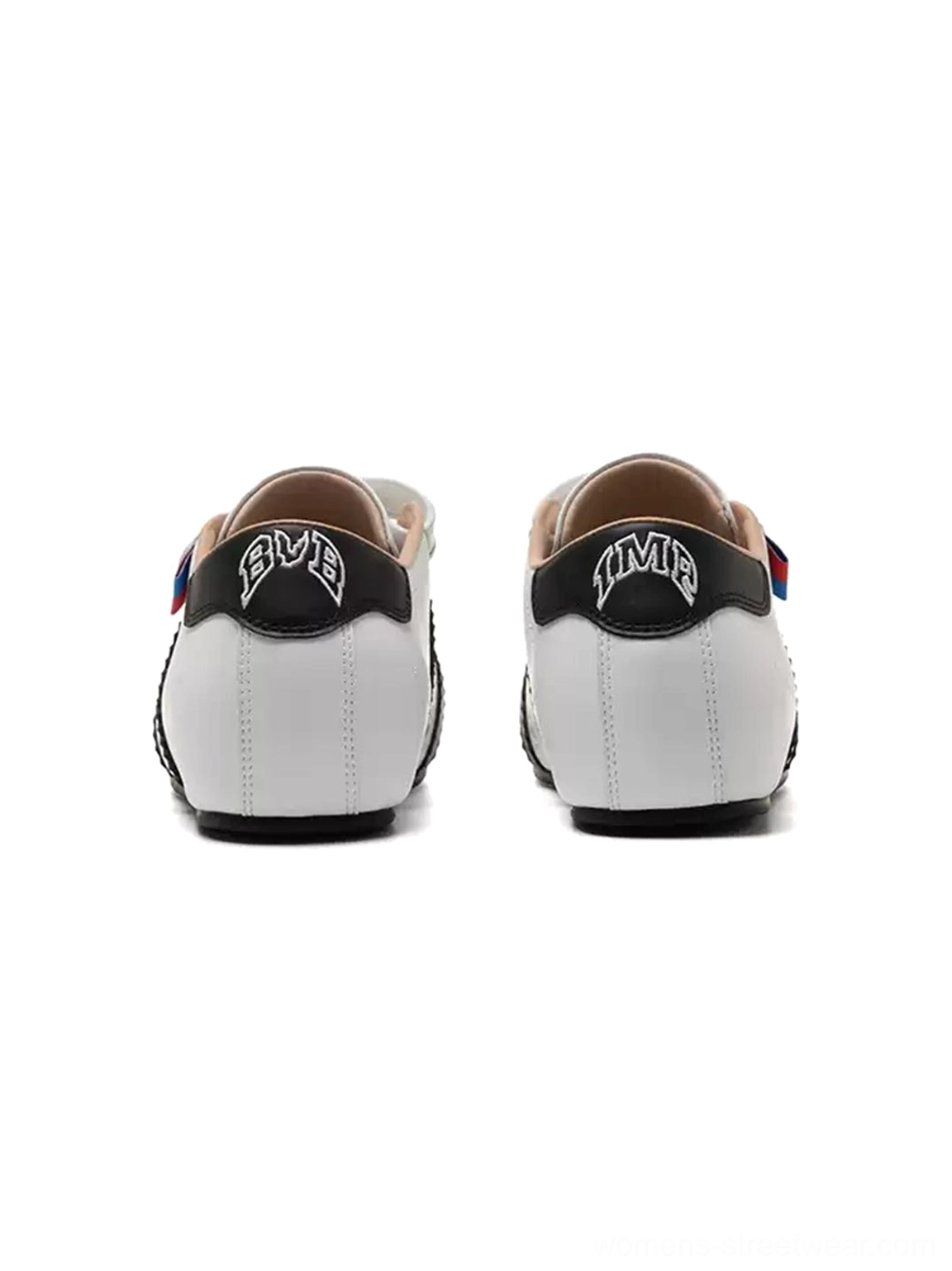 Rear view of white shell toe streetwear sneakers with contrast heel tabs and adjustable strap construction