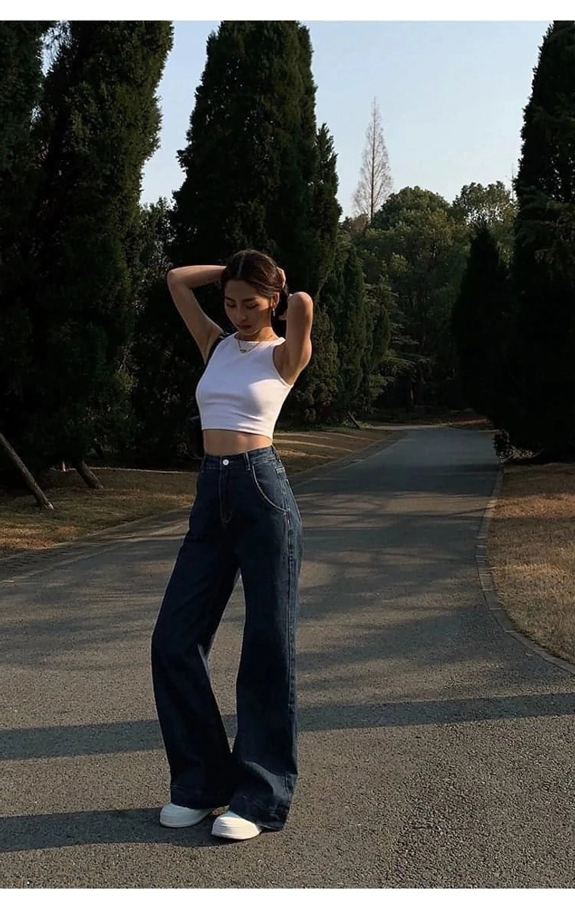 White sleeveless cropped tank top low-rise styling - pairing with low-rise maxi skirts for ironic Y2K fashion-forward contemporary streetwear aesthetic