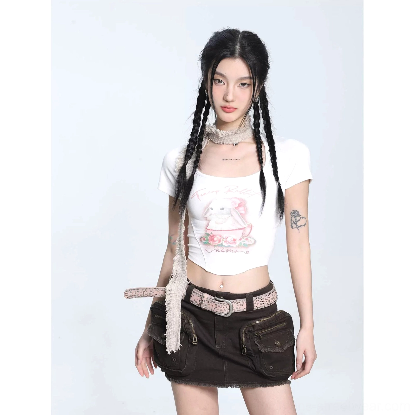 White slim-fit cropped short sleeve T-shirt with front bunny graphic styled with brown cargo mini skirt, leopard belt, and neck scarf
