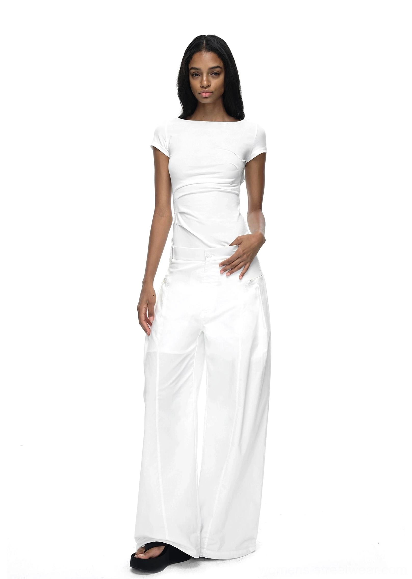 White slim-fit short-sleeve streetwear T-shirt with a clean minimalist silhouette styled with wide-leg trousers