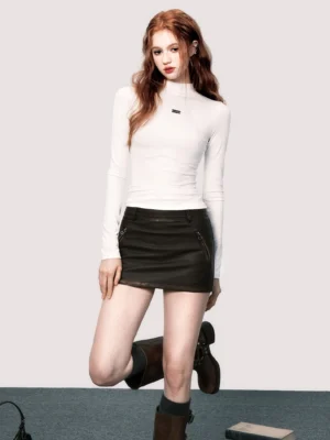 White slim mock neck long sleeve streetwear base layer top on model in a three-quarter front studio pose