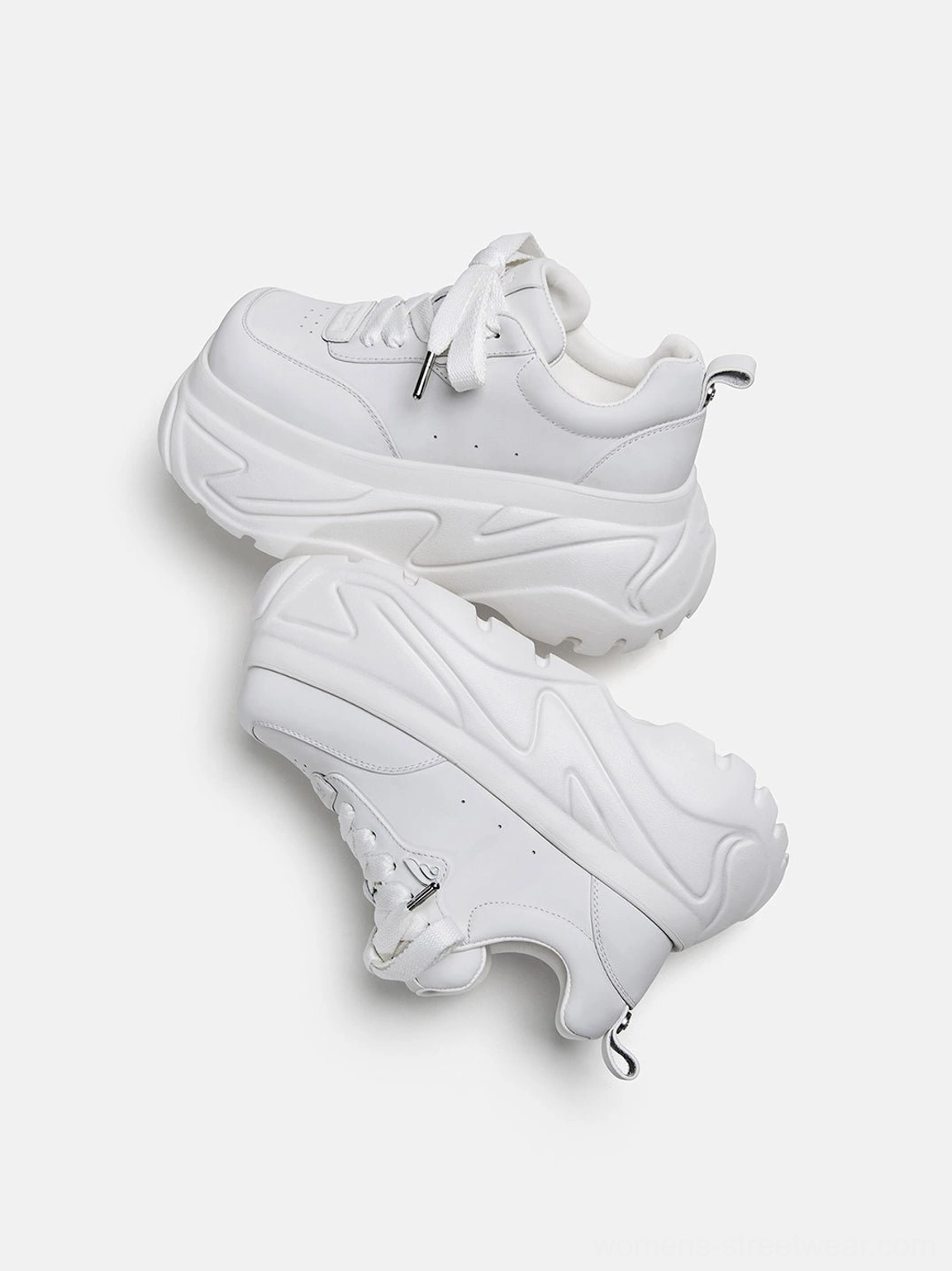 White square-toe platform leather sneakers displayed in a flat lay with a sculpted chunky outsole and front profile