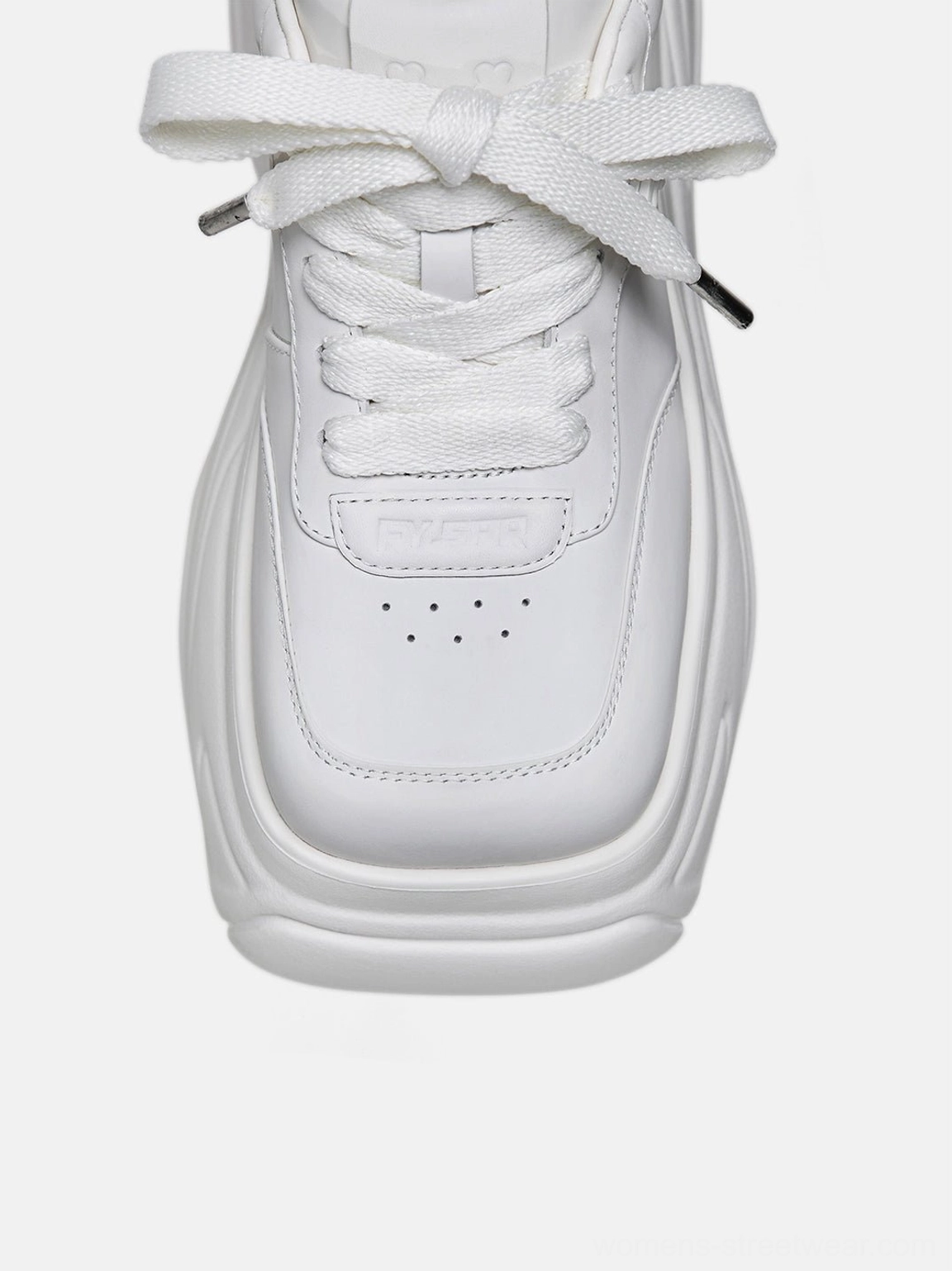 Close-up of white square-toe platform sneakers showing the perforated toe box, wide flat laces, and metal lace aglets