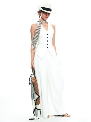 White tailored halter vest and wide-leg trousers streetwear set shown from the front side with fedora, striped scarf, and woven tote styling