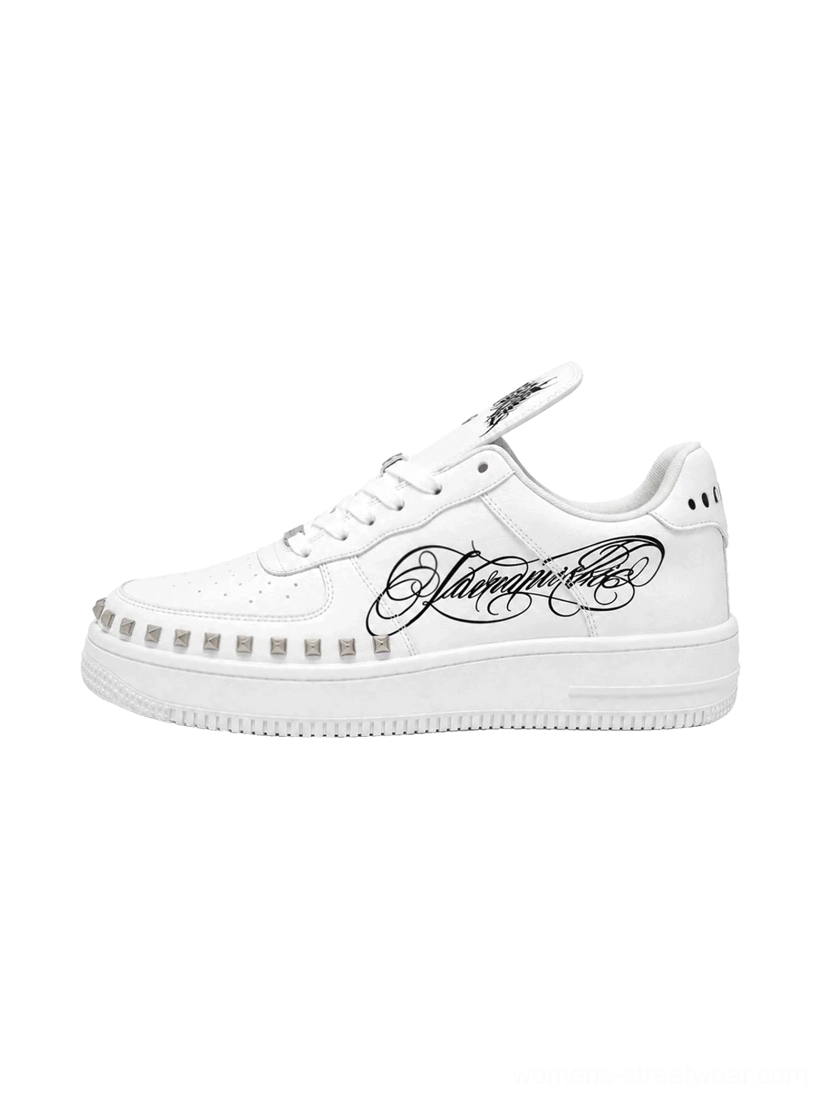 White tattoo style low top chunky leather sneakers with black cursive side print, silver studded midsole trim and lace up closure