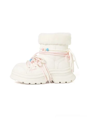 White teddy-lined chunky winter boots with plush fur cuffs, pink laces, colorful bead decorations, teddy bear charms, and thick platform lug soles shown from a front three-quarter view