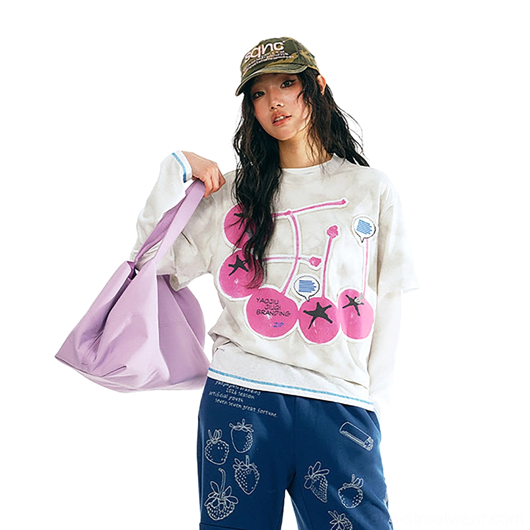 White tie-dye cherry pop graphic cotton streetwear t-shirt with pink cherry print styled with camo cap and purple tote bag