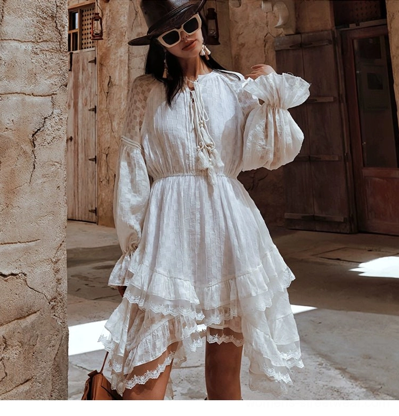 White tiered ruffle midi dress with relaxed fit lace-up neckline and flowing feminine silhouette for everyday styling