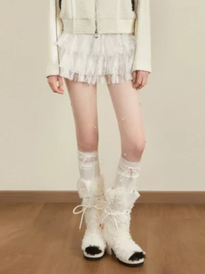 White tiered tulle mini skirt styled with lace knee-high socks and fluffy plush boots in a Korean Y2K streetwear outfit