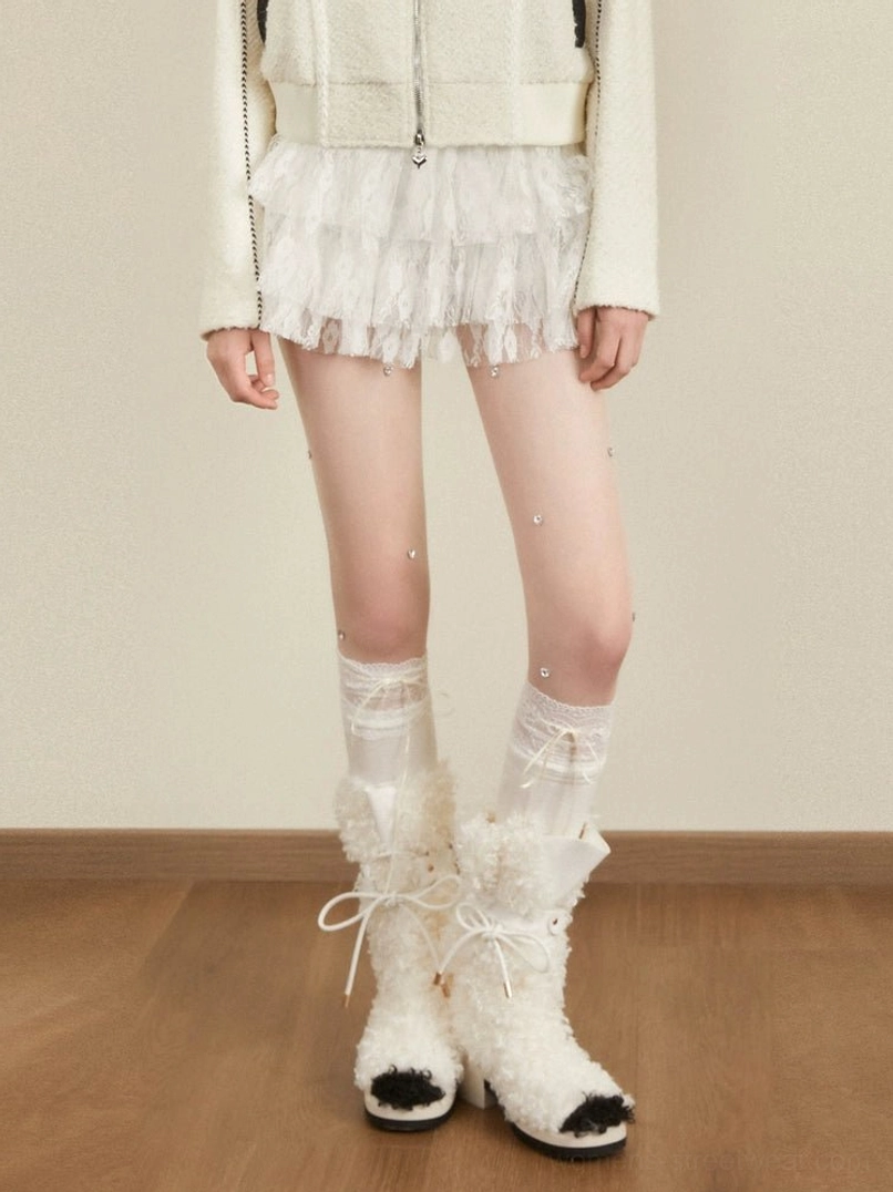 White tiered tulle mini skirt styled with lace knee-high socks and fluffy plush boots in a Korean Y2K streetwear outfit