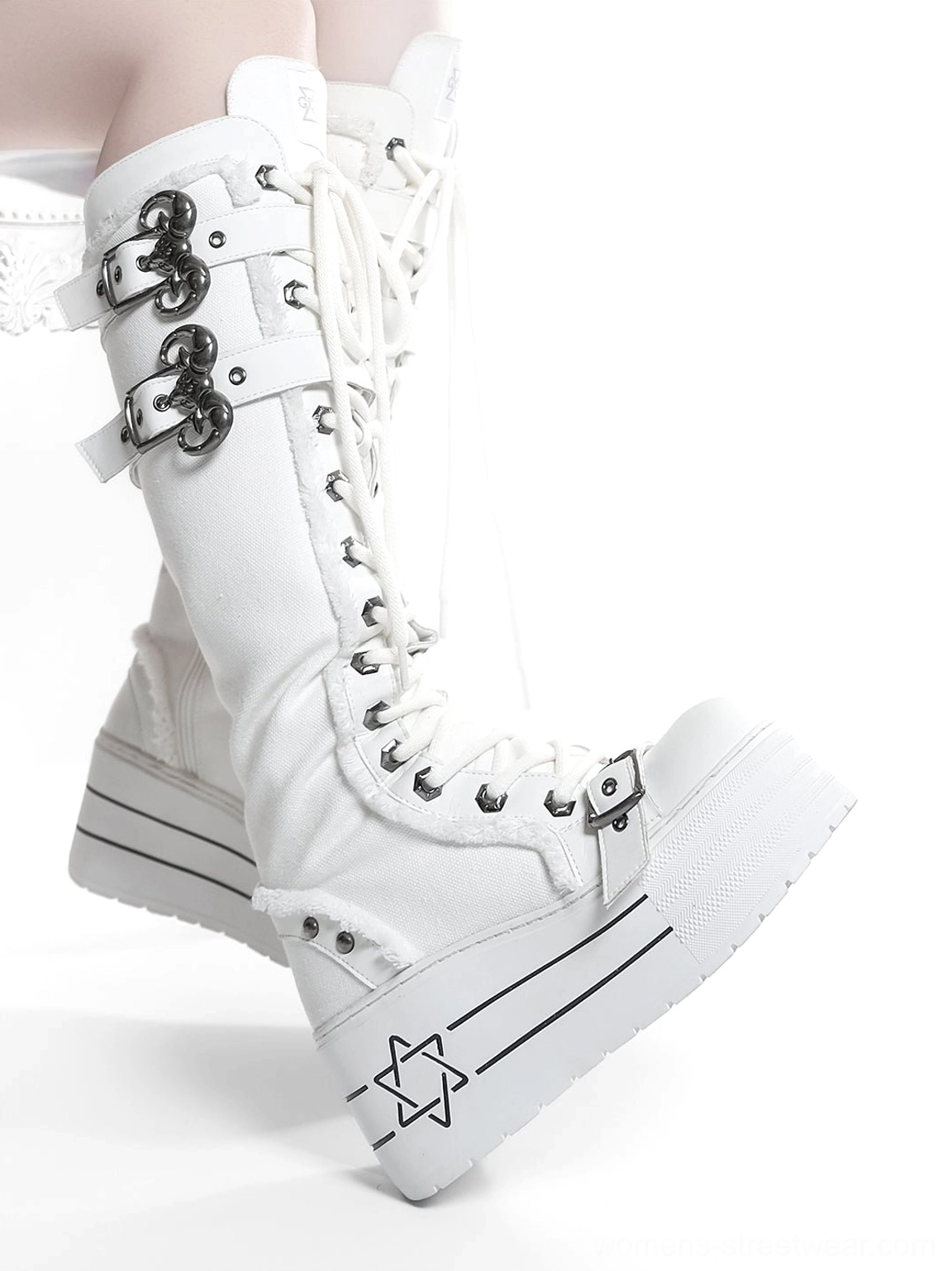 White triple-buckle knee-high platform combat boots with lace-up front and chunky gothic platform sole
