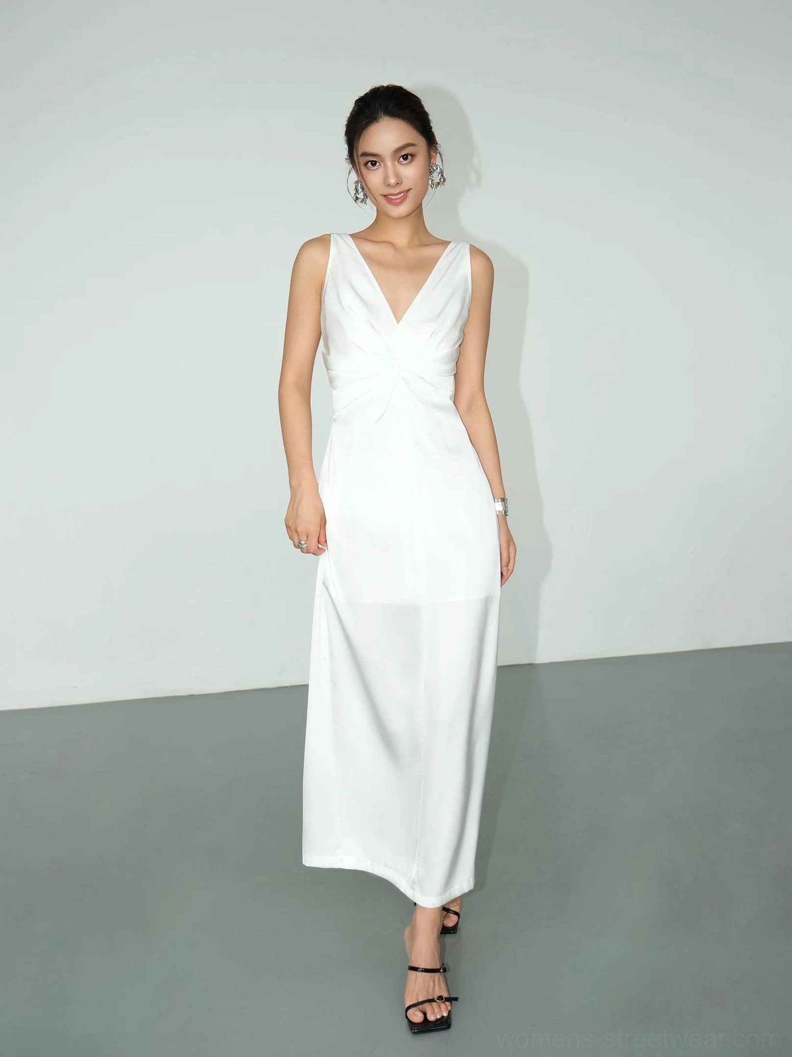 White twist-front satin maxi dress product image with sleek V-neckline, gathered waist detail and minimalist eveningwear aesthetic