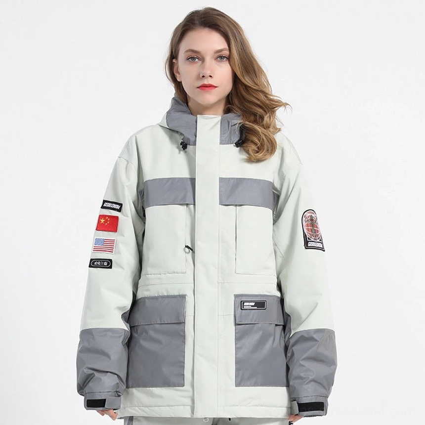White unisex reflective panel ski jacket front view with reflective chest details, grey panels, hood, sleeve embroidered patches, and cargo pockets