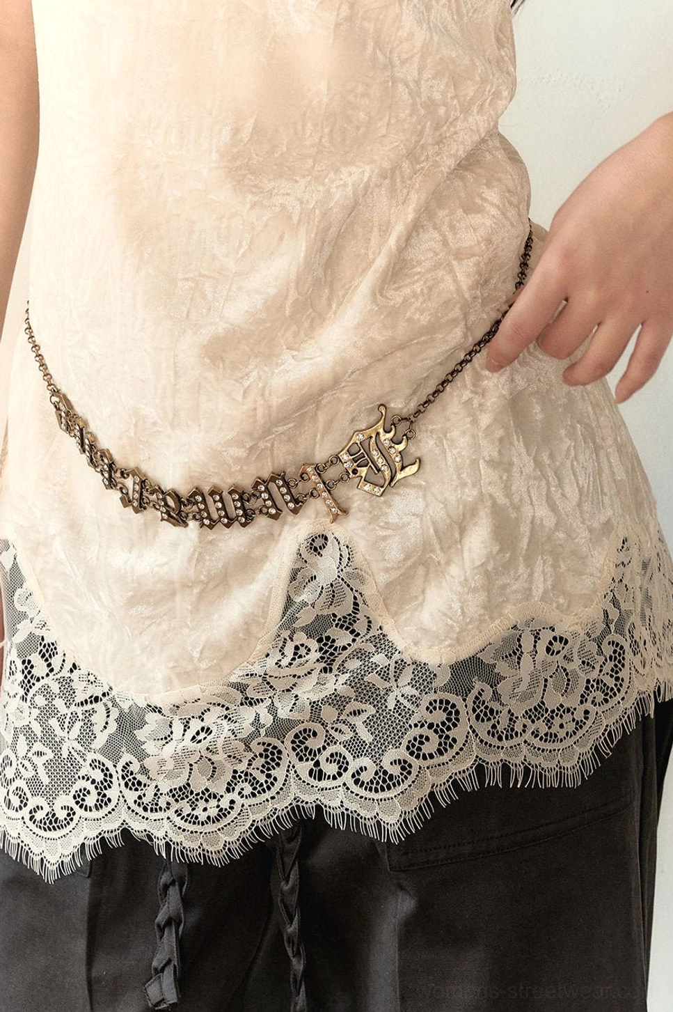 Close-up of white velvet lace camisole hem with scalloped lace panel and textured velvet fabric