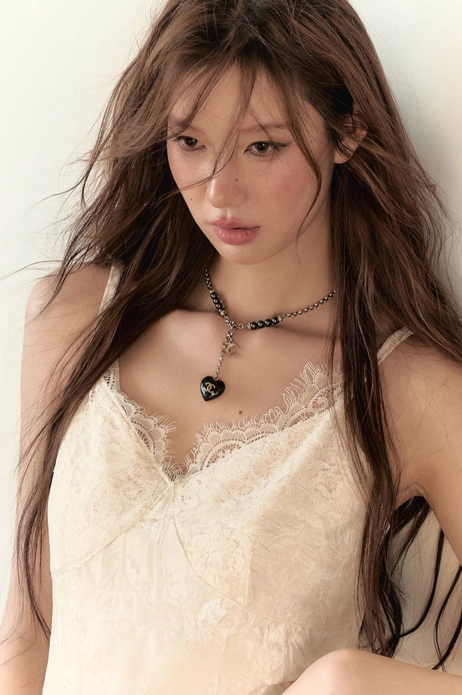 Close-up of white velvet lace camisole V-neck with delicate eyelash lace trim and soft velvet texture