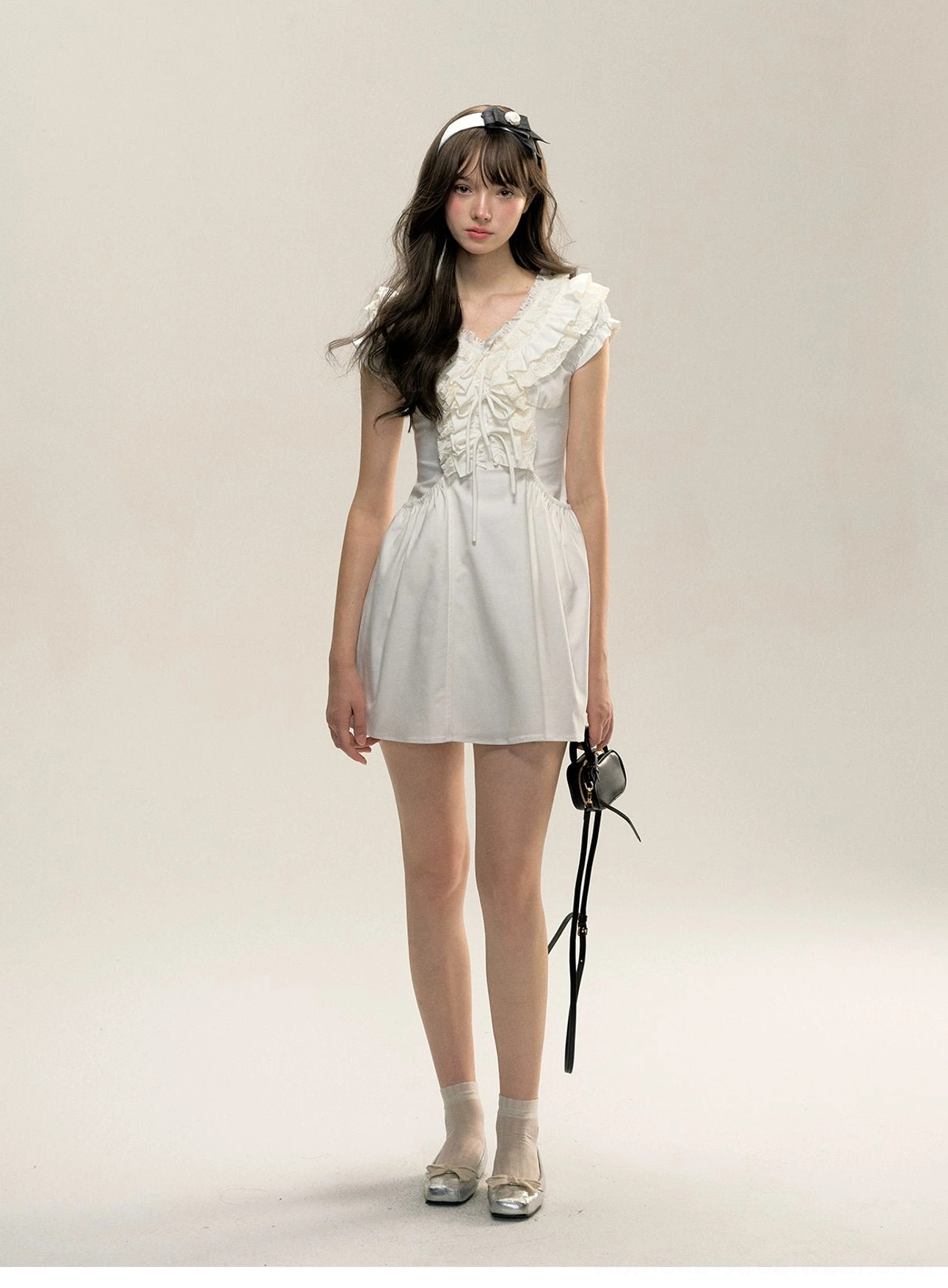 White Victorian-inspired cotton mini dress with ruffled V-neck, cap sleeves, and flared skirt